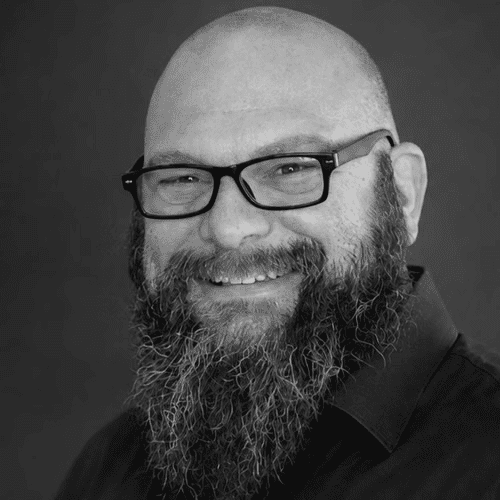 Portrait of Bobby Baker, a professional stylist at Indigo, showcasing their expertise and style.