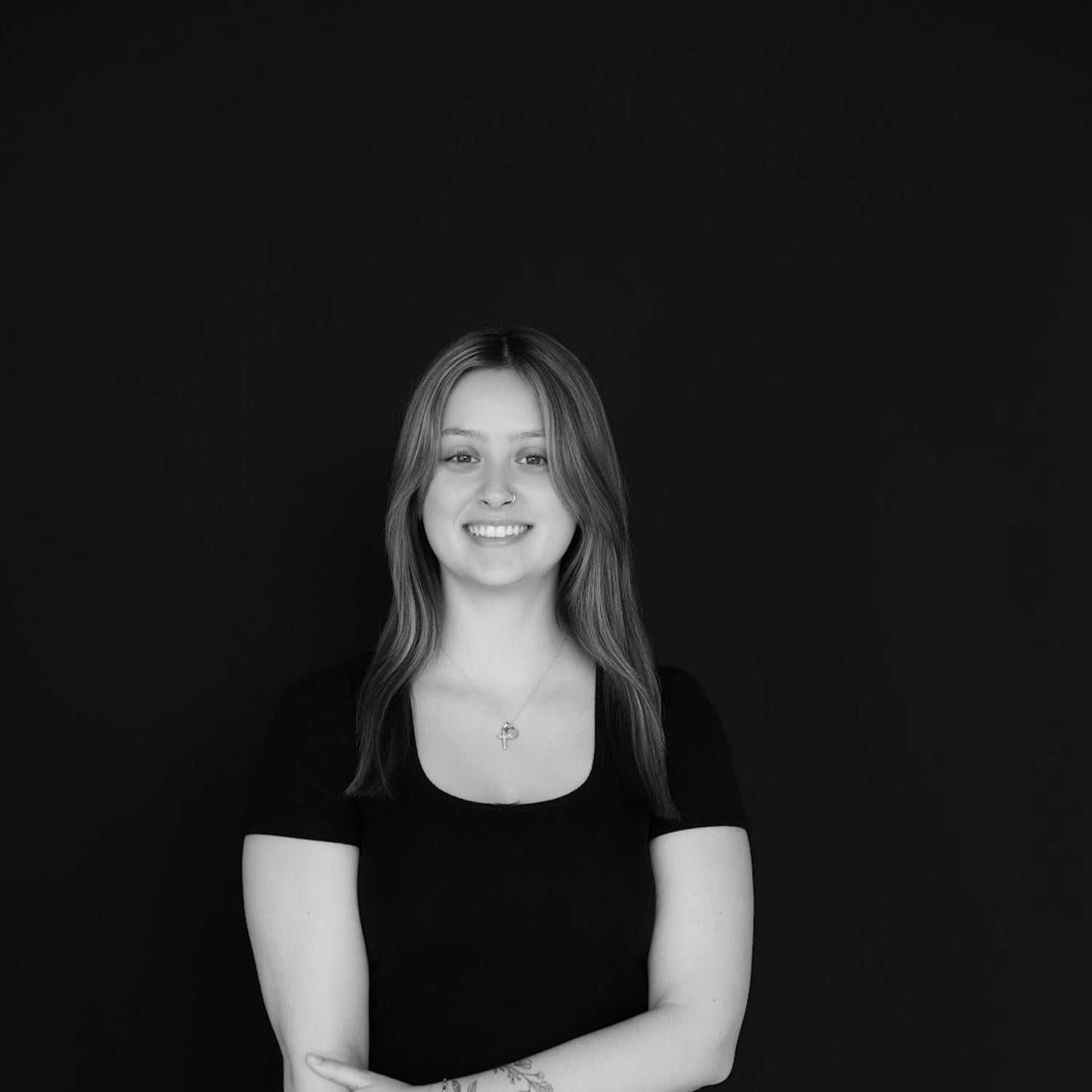 Portrait of Kaitlyn, a professional stylist at Indigo, showcasing their expertise and style.