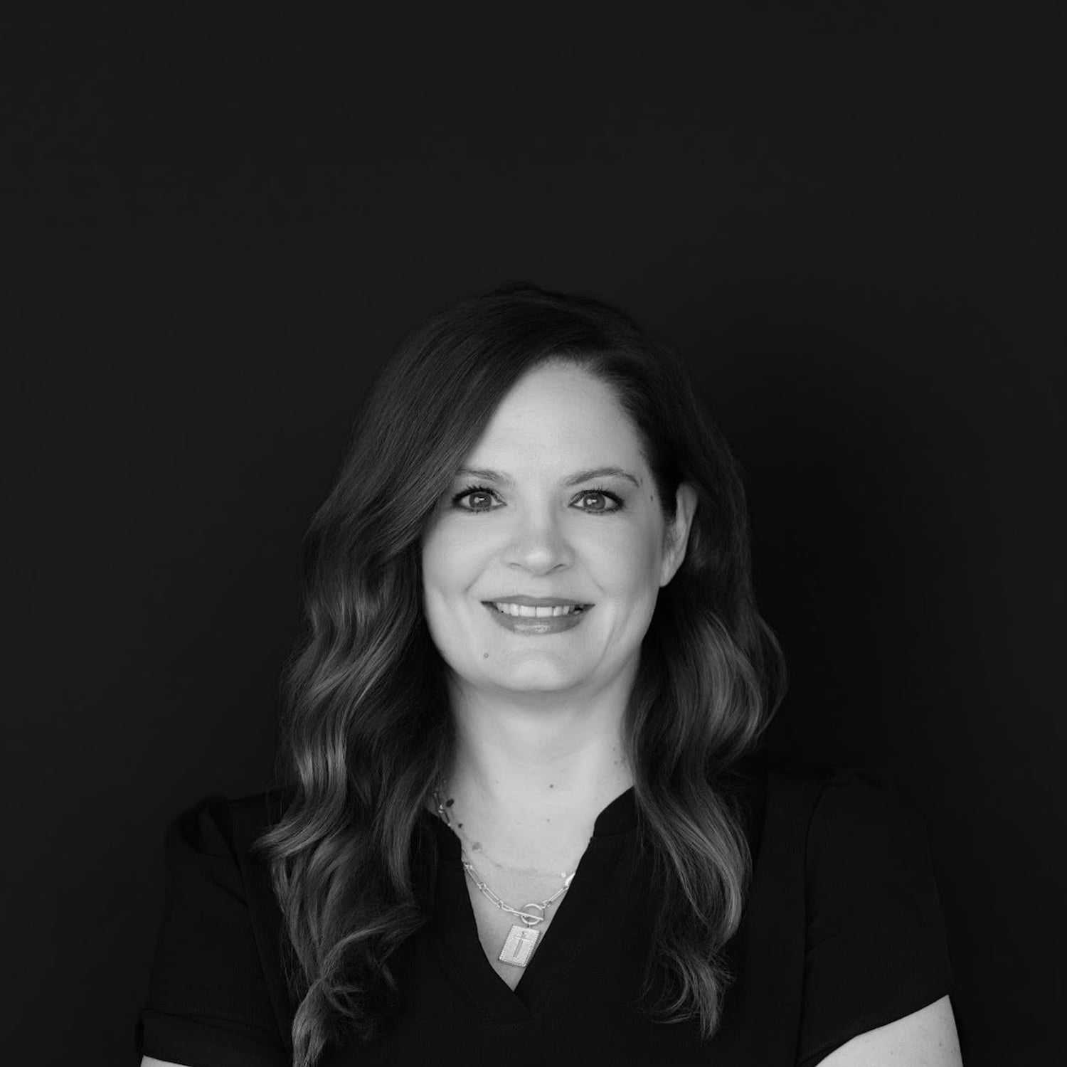 Portrait of Krystal, a professional stylist at Indigo, showcasing their expertise and style.