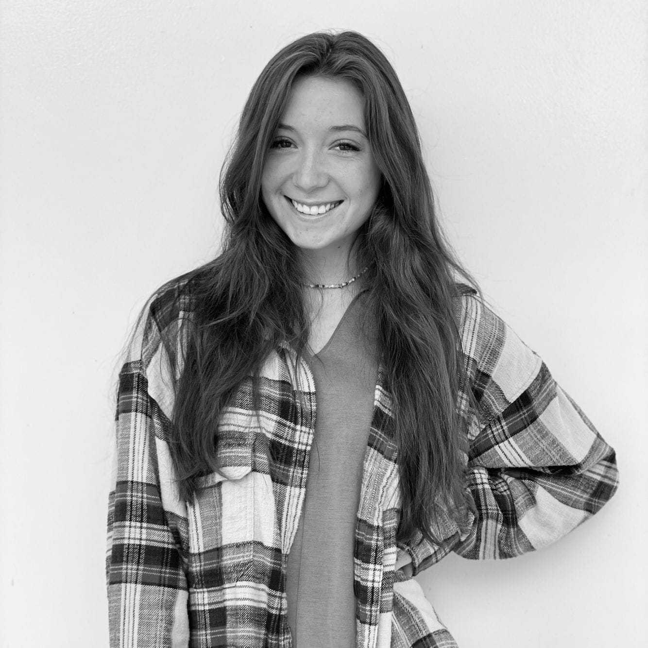 Portrait of Brianna, a professional stylist at Indigo, showcasing their expertise and style.
