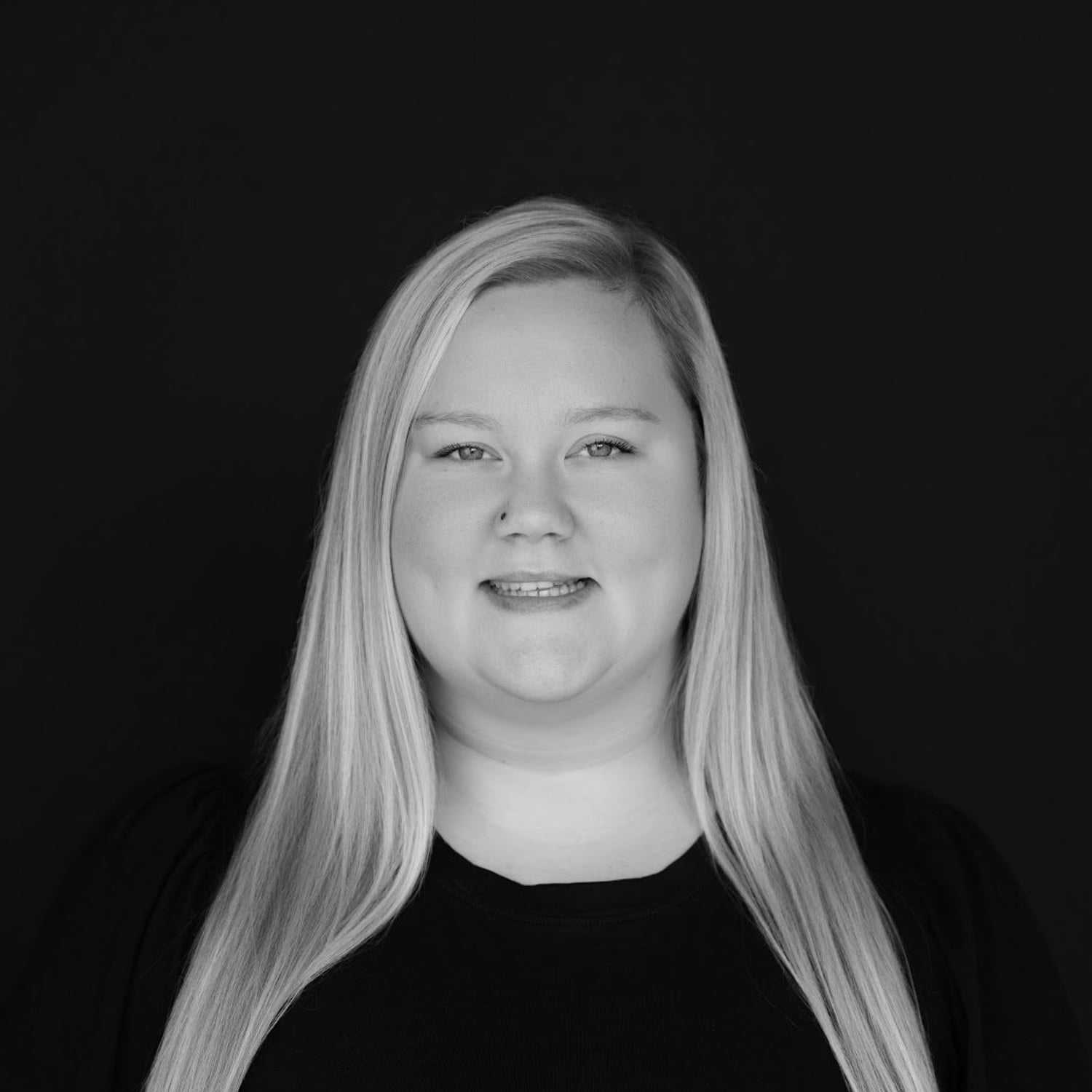 Portrait of Emily Brunson, a professional stylist at Indigo, showcasing their expertise and style.