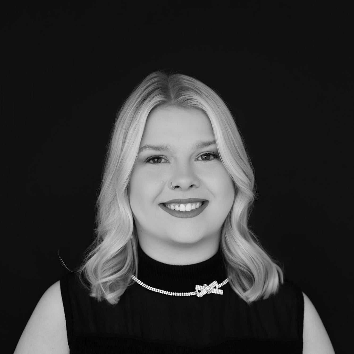 Portrait of Cassie, a professional stylist at Indigo, showcasing their expertise and style.